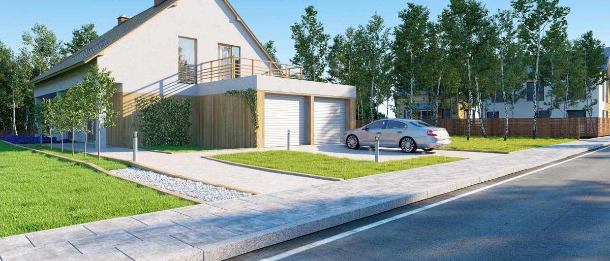 Modernes Haus mit einer Doppelgarage vor dem ein Auto steht.