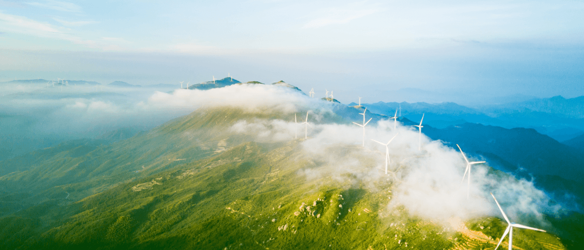 Bird's eye view of hill with wind turbines